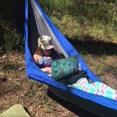 enjoying hammock in forest trees
