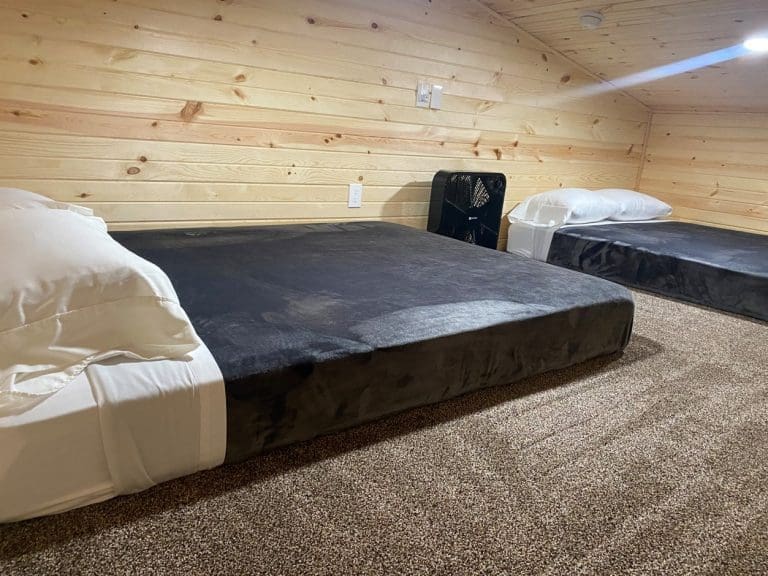 beds and fans in loft in 400sq Ft deluxe cabins